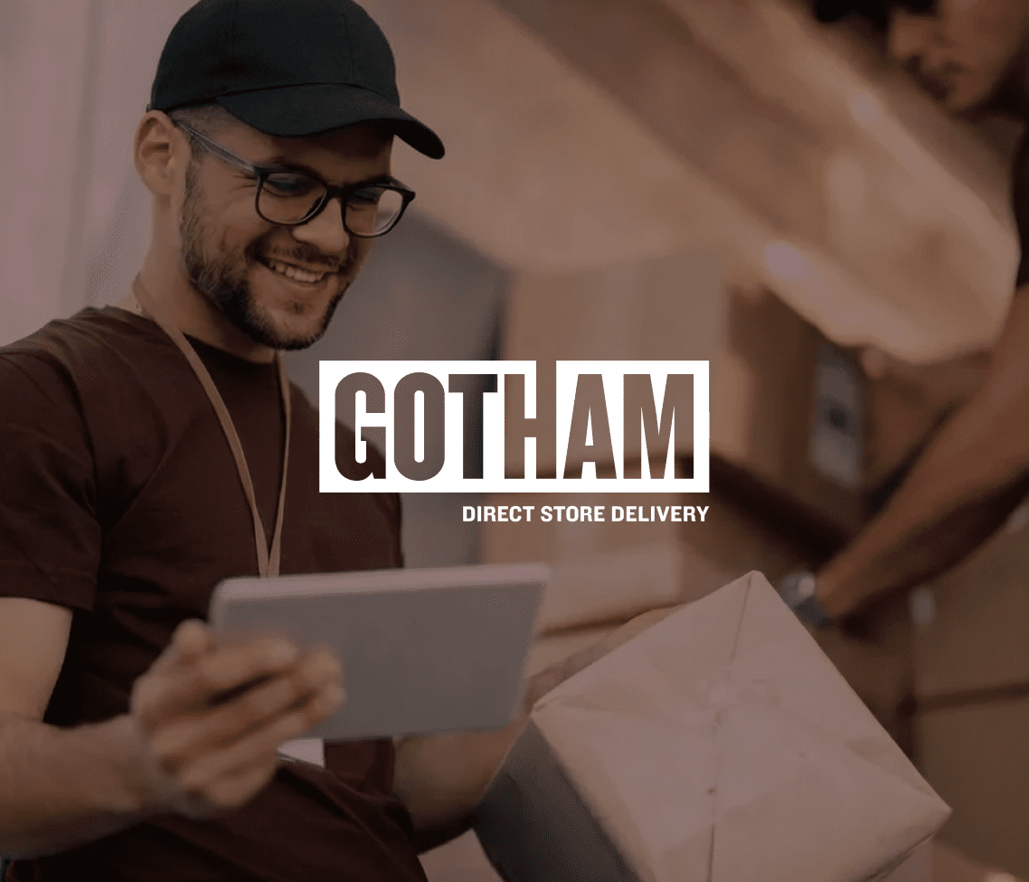 A cheerful delivery worker with glasses and a cap holds a tablet and package, while another moves boxes. GOTHAM DIRECT STORE DELIVERY text appears.